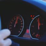 A detailed view of a car's speedometer and dashboard, emphasizing speed and technology.